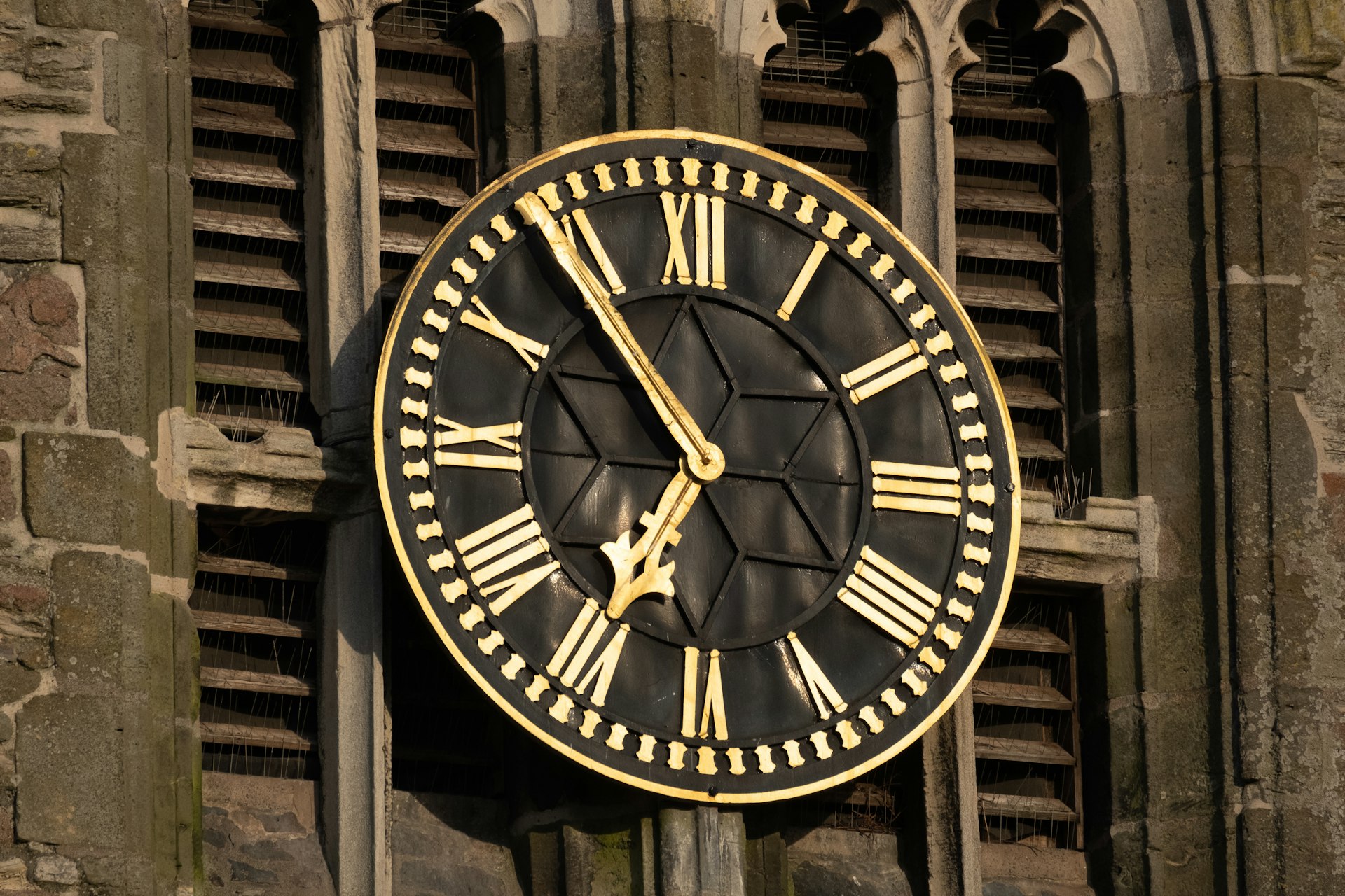 a clock on the side of a building with roman numerals